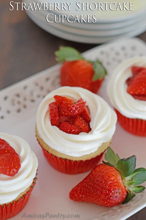 A plate, with Strawberry cupcakes sitting on top