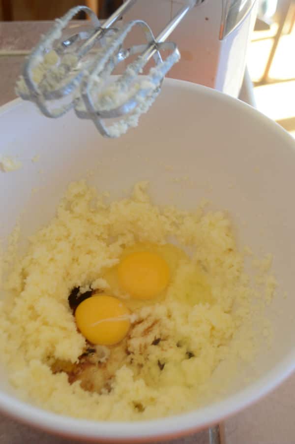 A photo showing a bowl with a mixture and eggs