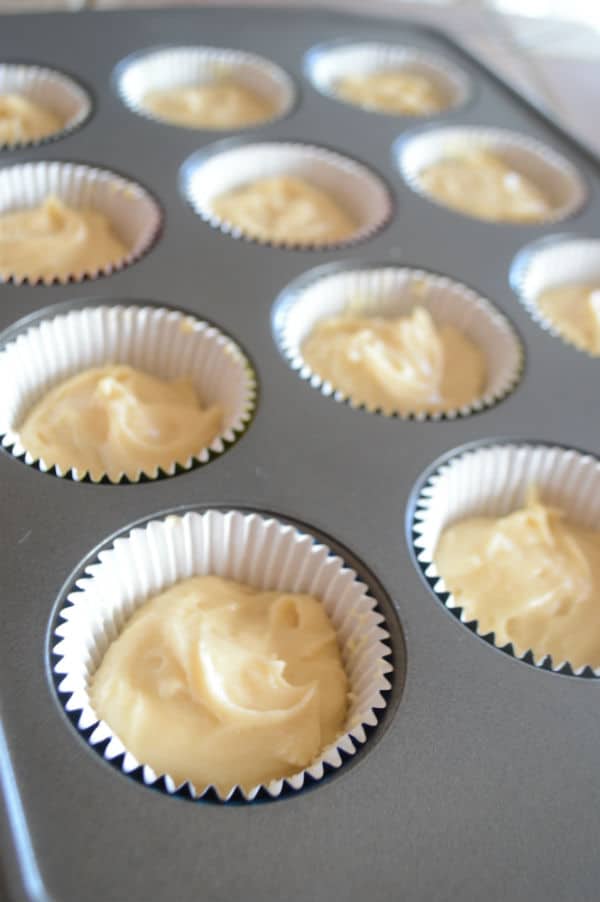 A photo showing a tray with paper cups and dough