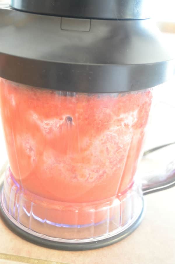 A blender with strawberry juice