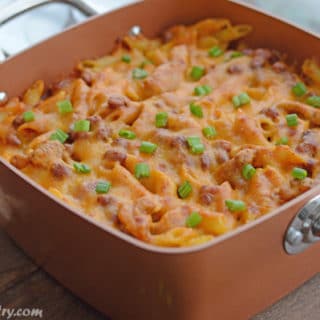 A pan of food on a table, with Chicken and Enchilada