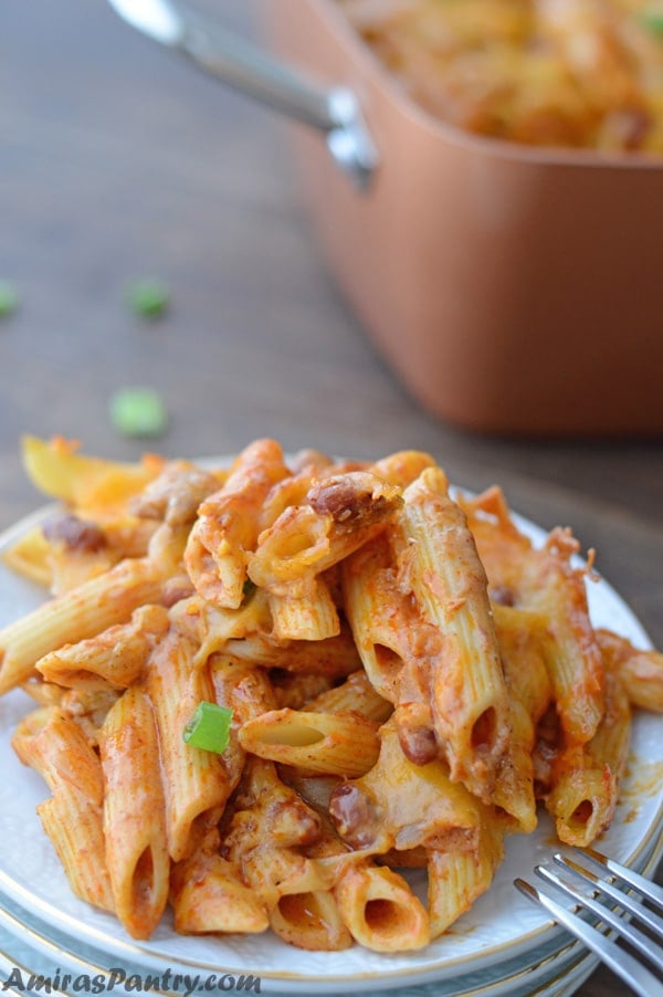 A plate of food with a Pasta and Enchilada