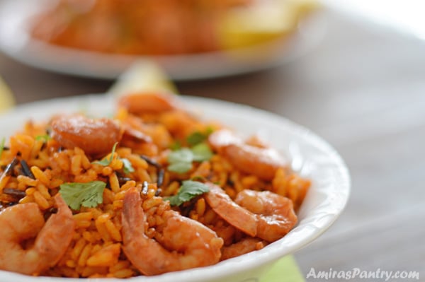 A plate of spicy whild rice and shrimp garnished with fresh cilantro.
