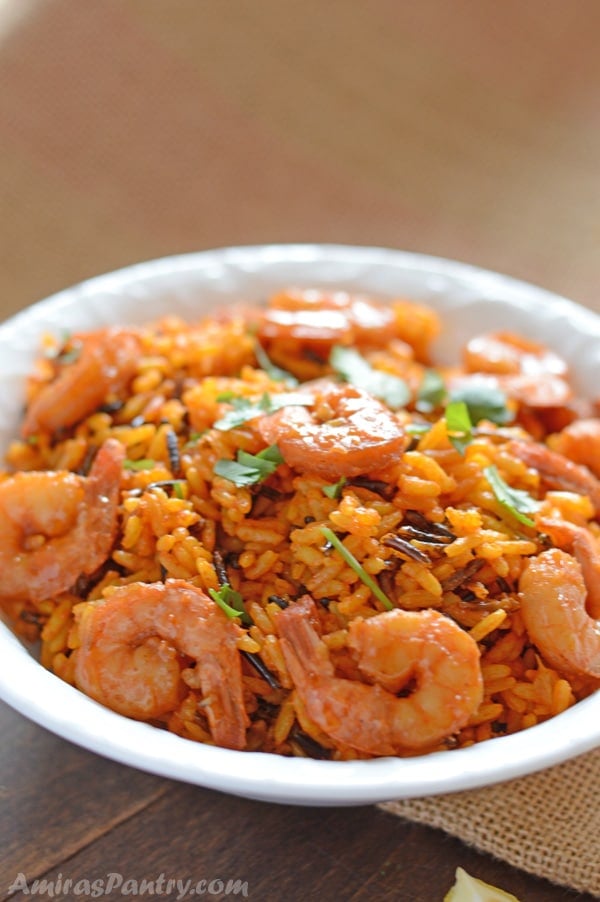 A plate of spicy wild rice and shrimp ganrished with fresh cilantro