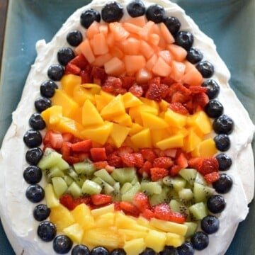 A close up of cake on a plate with fruits