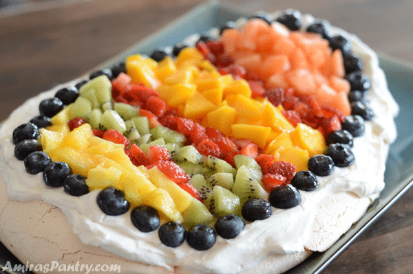 A plate of food on a table, with Pavlova and Fruit