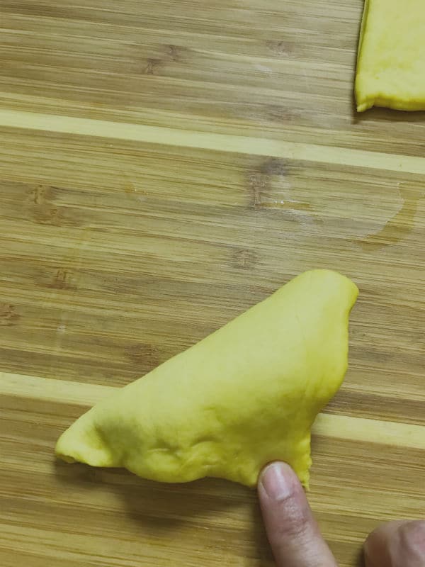 A close up of a folded dough with stuffing