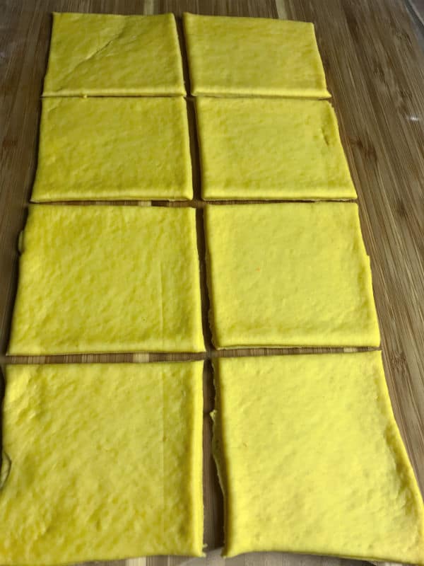 A photo showing cut dough on a wooden table