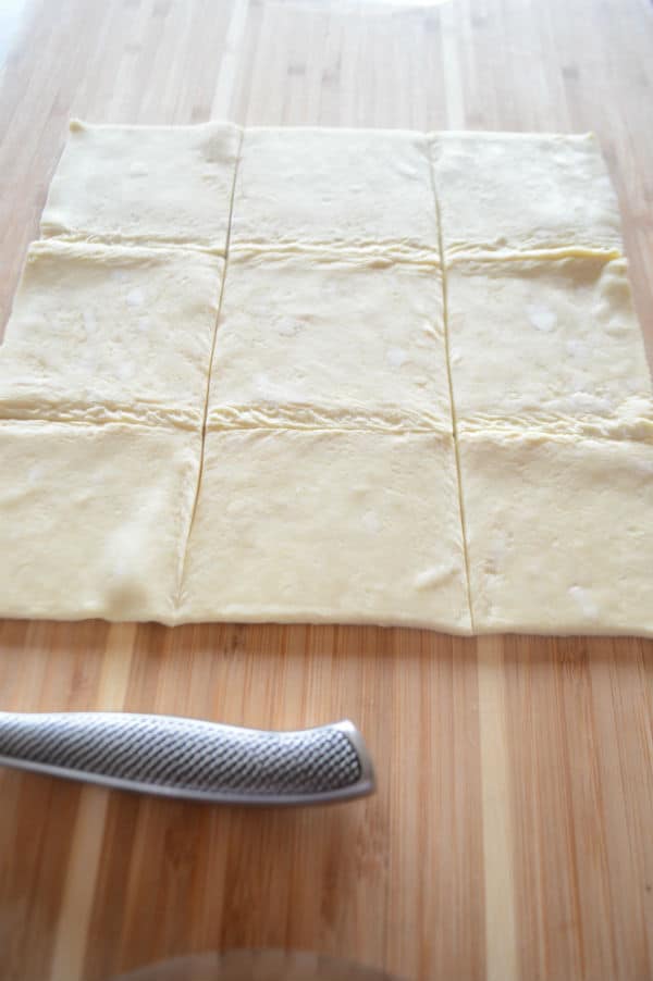 A cut dough on a wooden table and knife