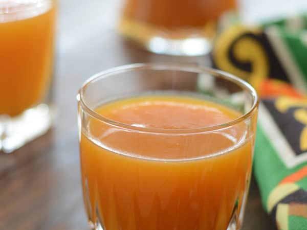 A close up of glass of apricot juice