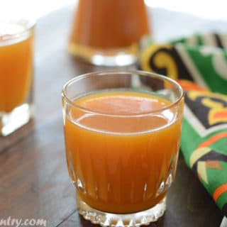 A close up of glass of apricot juice