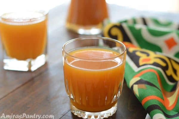 Three glass of apricot juice on a wooden table