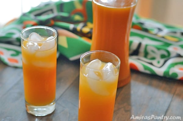 Three glass of apricot juice on a wooden table