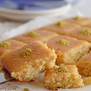 A plate of food, with Basbousa cake pieces