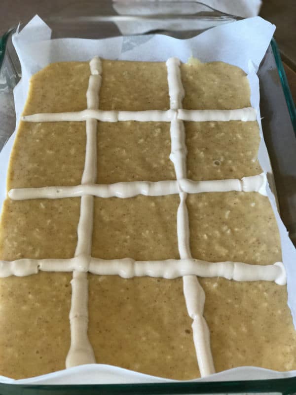 A close up of a pan with Babousa cake mixture