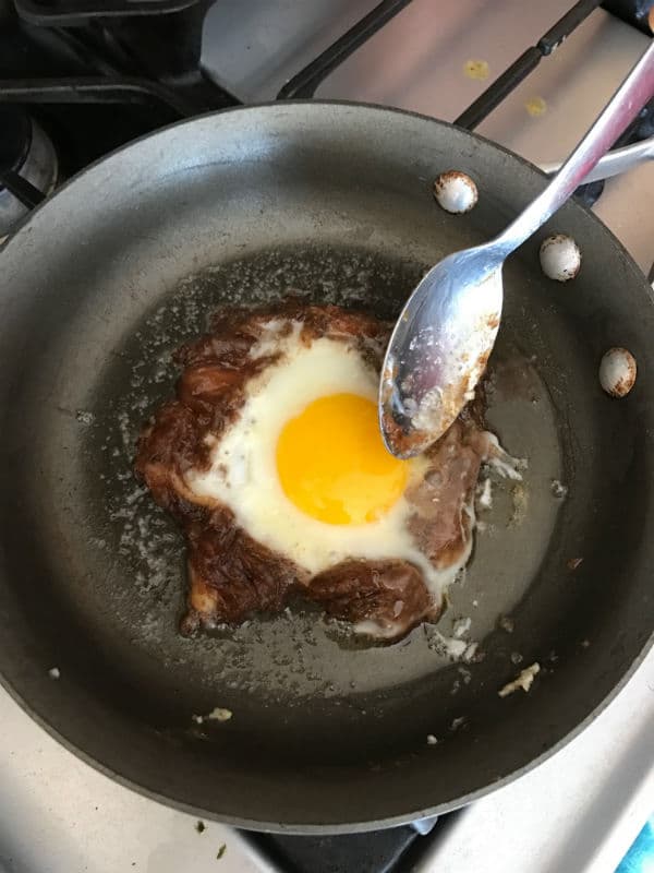 A pan of food on a stove top oven with date paste and egg