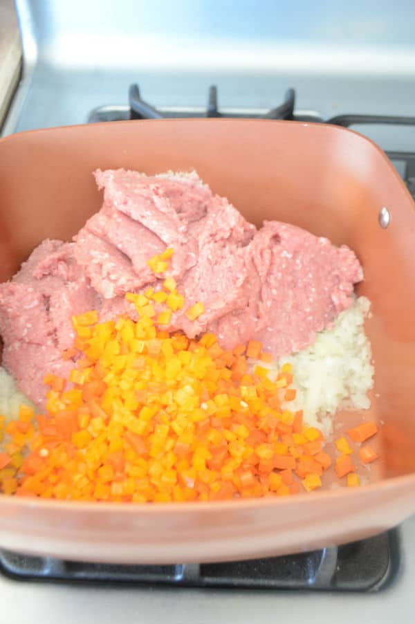 A bowl with food in it, with meat and vegetables