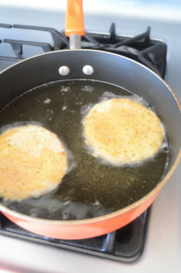 A pan frying bread on a stove