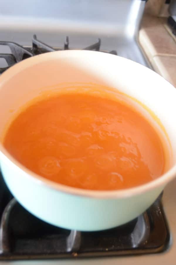 A pan of Apricot juice on a stove top