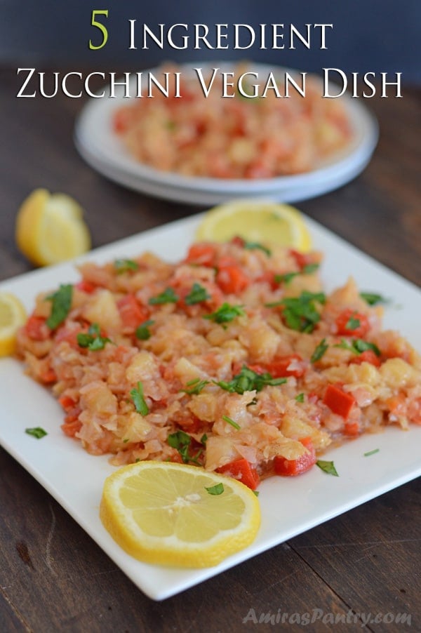 A close up of a plate of food, with zucchini and lemons