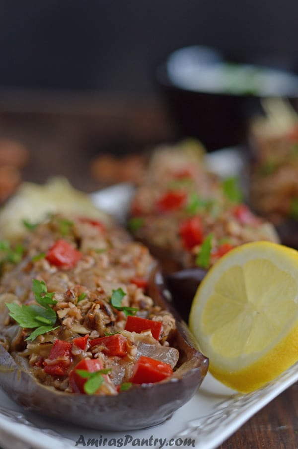 A close up of food on a table, with Walnut and Stuffed eggplant