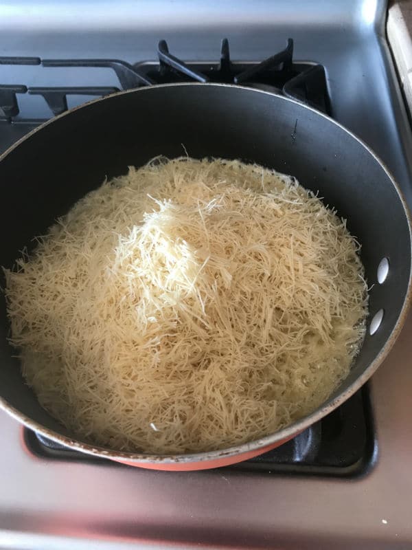 A pan of food on a stove, with knafeh