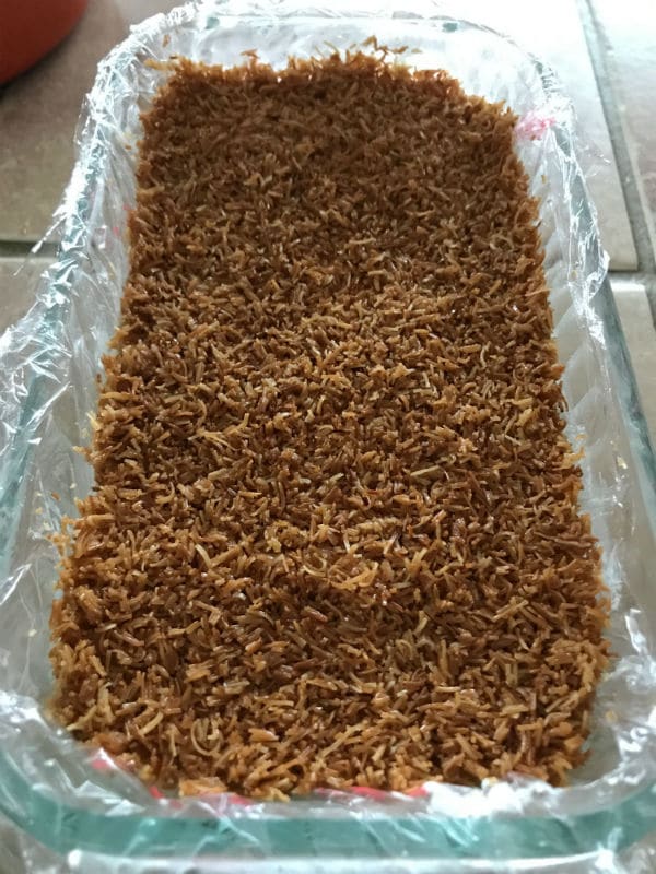 A mixture of knafeh in a glass pan