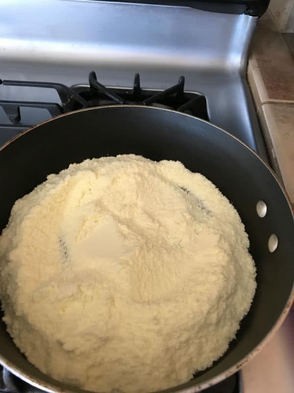 A close up of a pan on a stove, with mixture