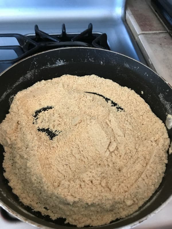 A close up of a pan on a stove, with mixture