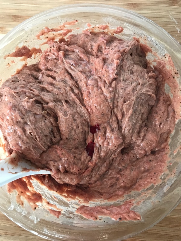 A photo showing a step mixing corned beef in a bowl with spoon