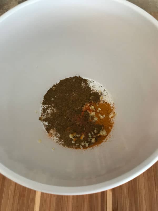 A bowl of food on a plate, with spice mix
