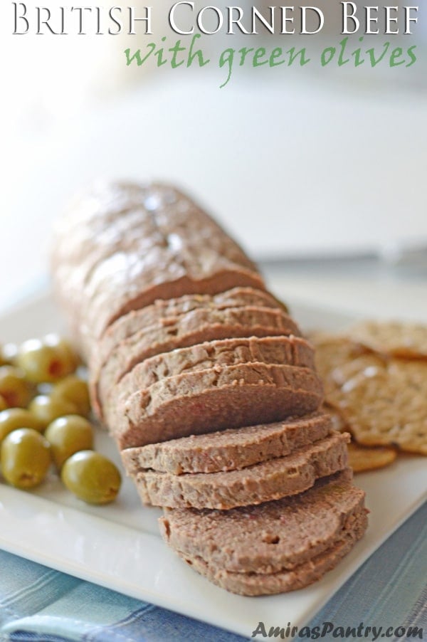 A photo showing cut slices of Corned beef with green olives