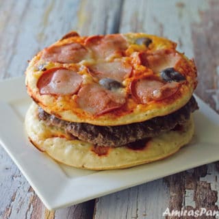 A pizza burger sitting on a plate
