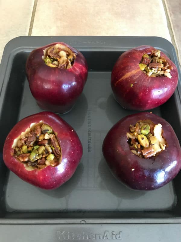 A pan filled with red apples stuffed baklava