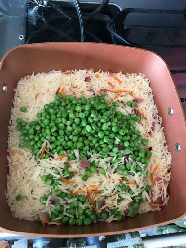 A close up for a pot with vegetables and rice