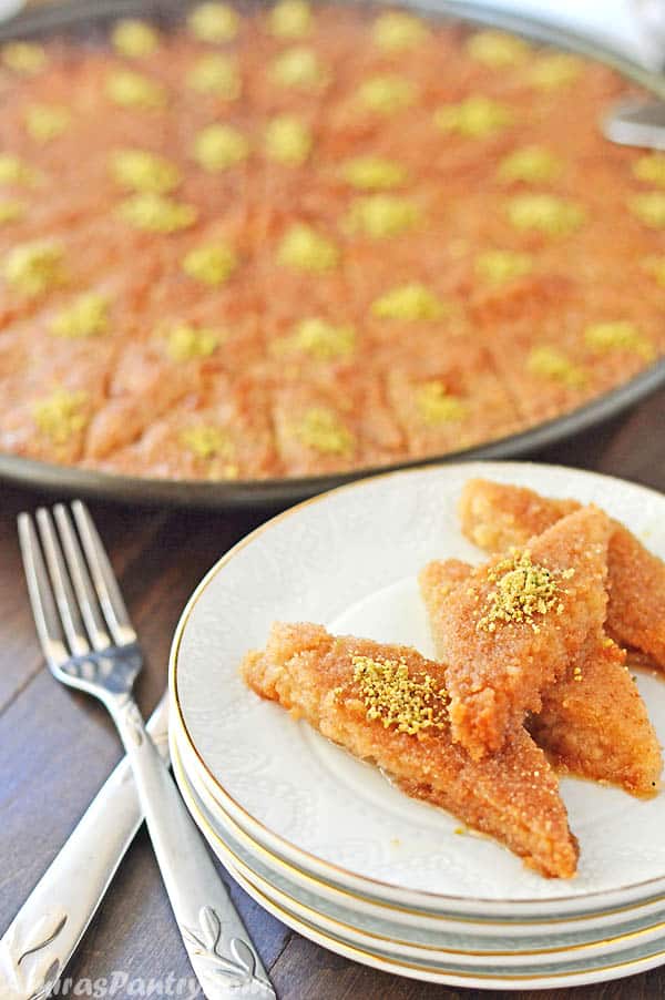 A plate of food on a table, with Basbousa and nuts