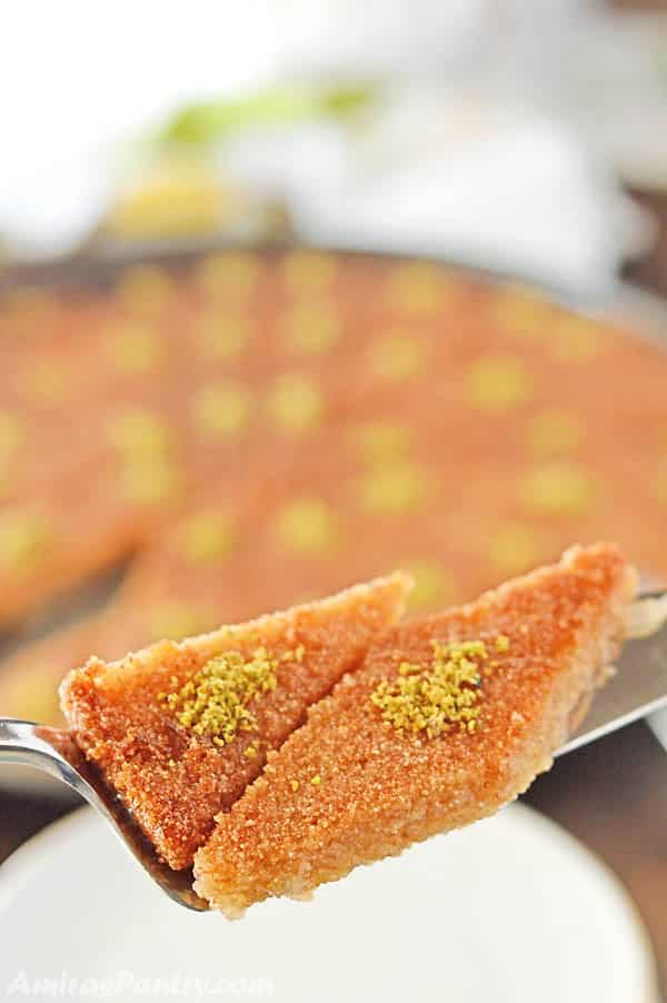 A close up of a slice cut out of Basbousa