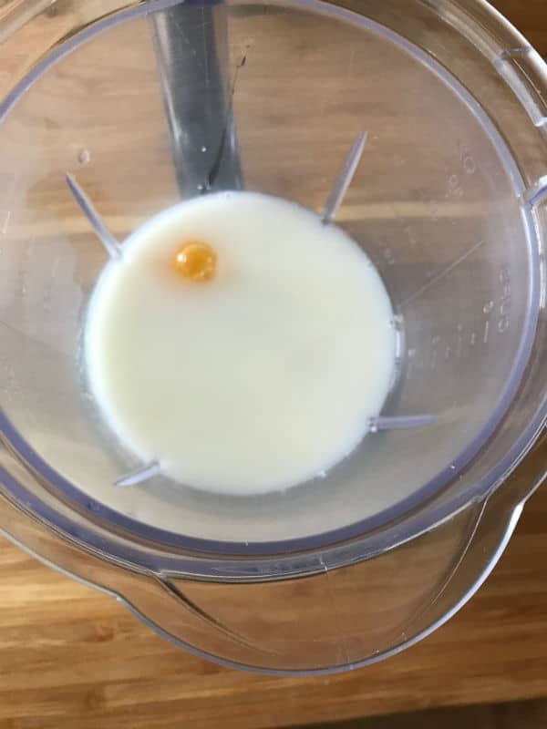 A photo showing milk in a blender