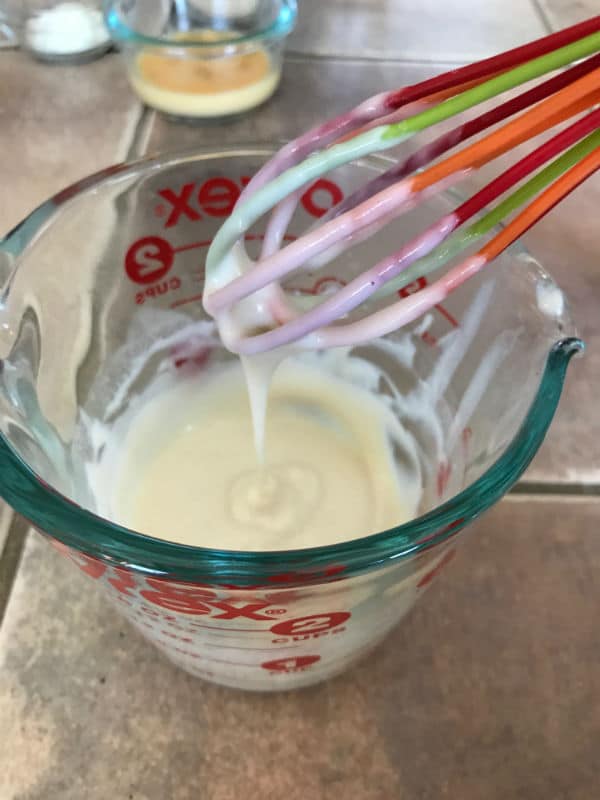 A cup of dough mix on a table