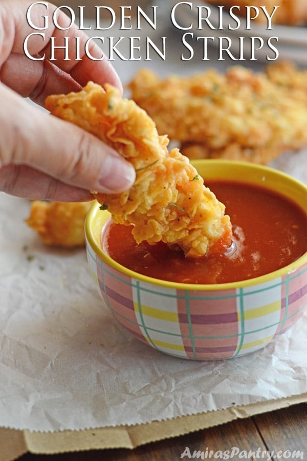 A close up for golden chicken strip dipped in sauce