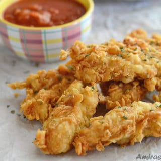 A close up of food on a table, golden chicken strips