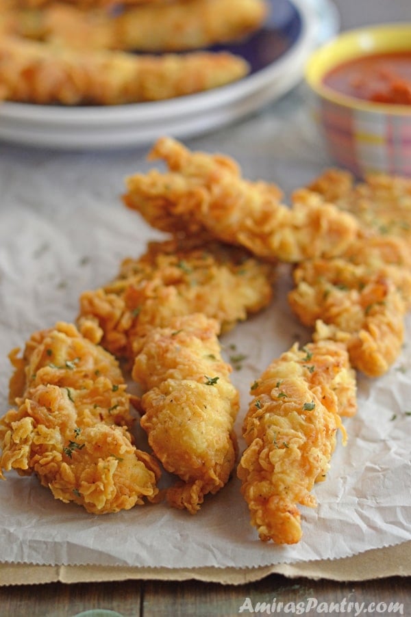 A close up of food on a table, golden chicken strips