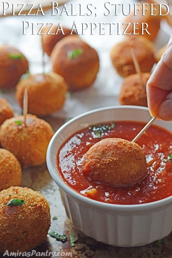 A plate of food on a table, with Pizza balls and dip