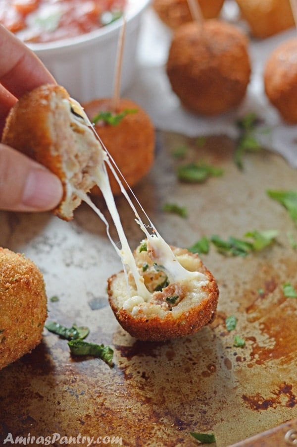 A close up of pizza balls cut with cheese