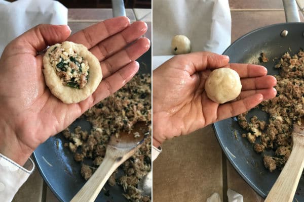 A person holding a dough and stuffing it