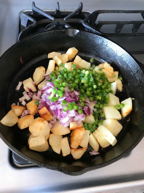 A pan filled with food, with Potato and vegetables