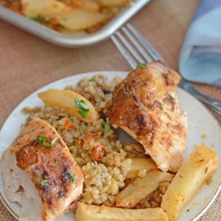 A plate of food on a table, with chicken and freekeh