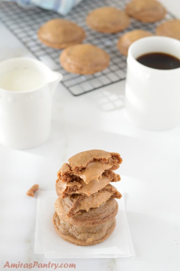 A close up of a peanut butter cookies and a cup of coffee