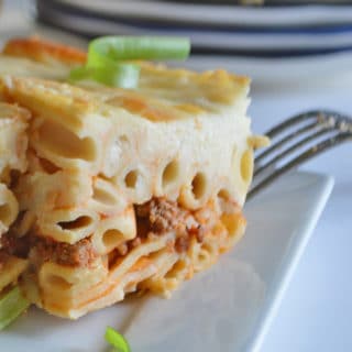 A close up of a piece of Baked Pasta with ground beef in a dish