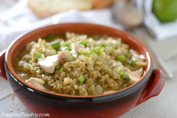 Freekeh soup in a bowl garnished with green onions.